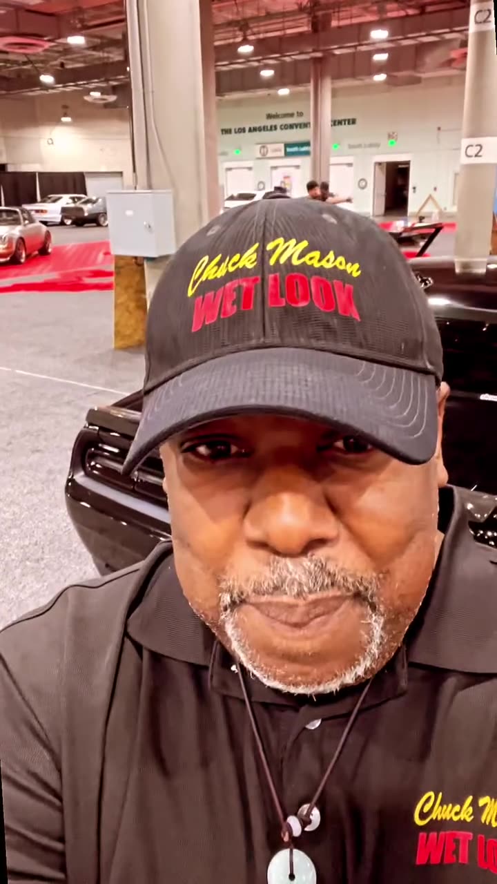 Chuck Mason on camera on an auto show floor