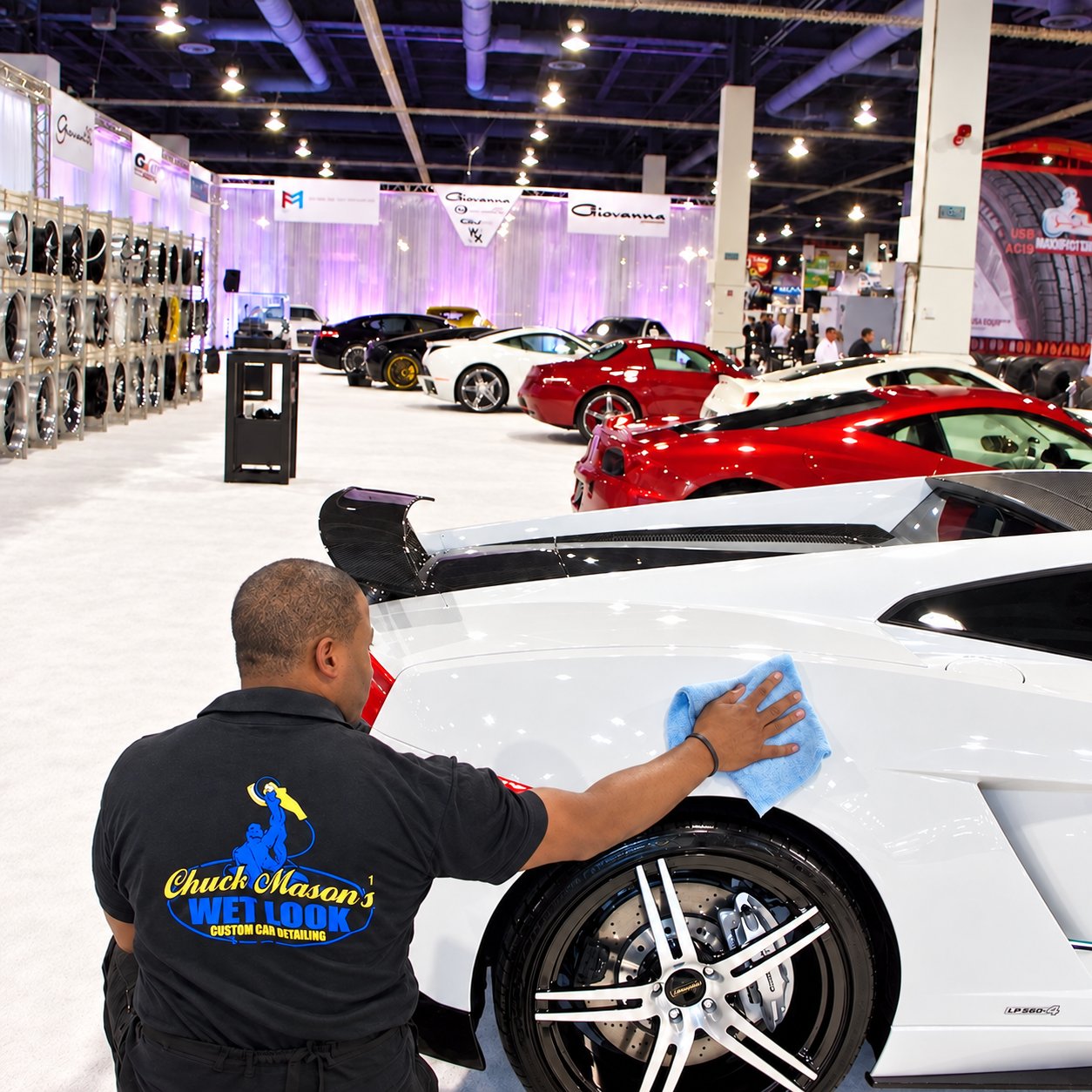 Chuck Mason finishing the fender of a white exotic car