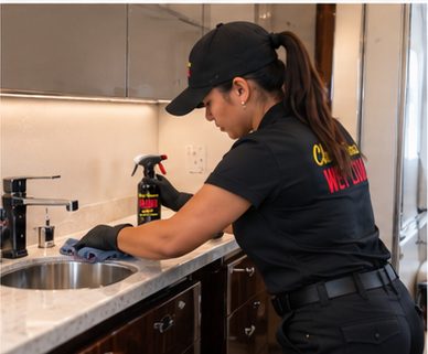 Crew member cleaning the galley counter